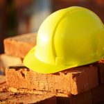 Under construction, helmet and bricks for building site
